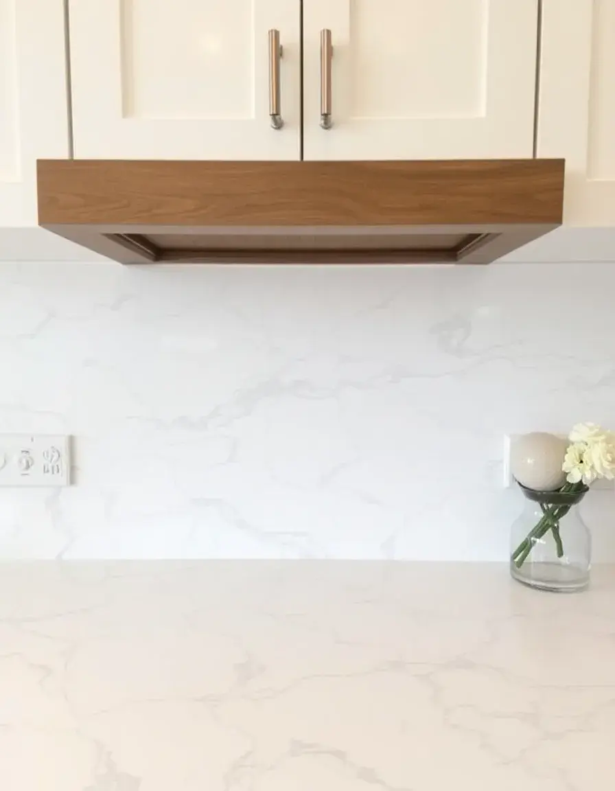 Matching veined white quartz backsplash tile