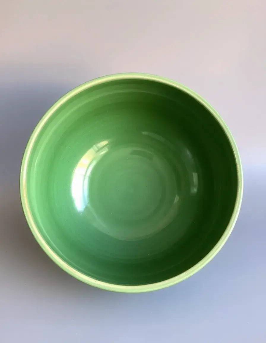Large green ceramic mixing bowl with glazed finish